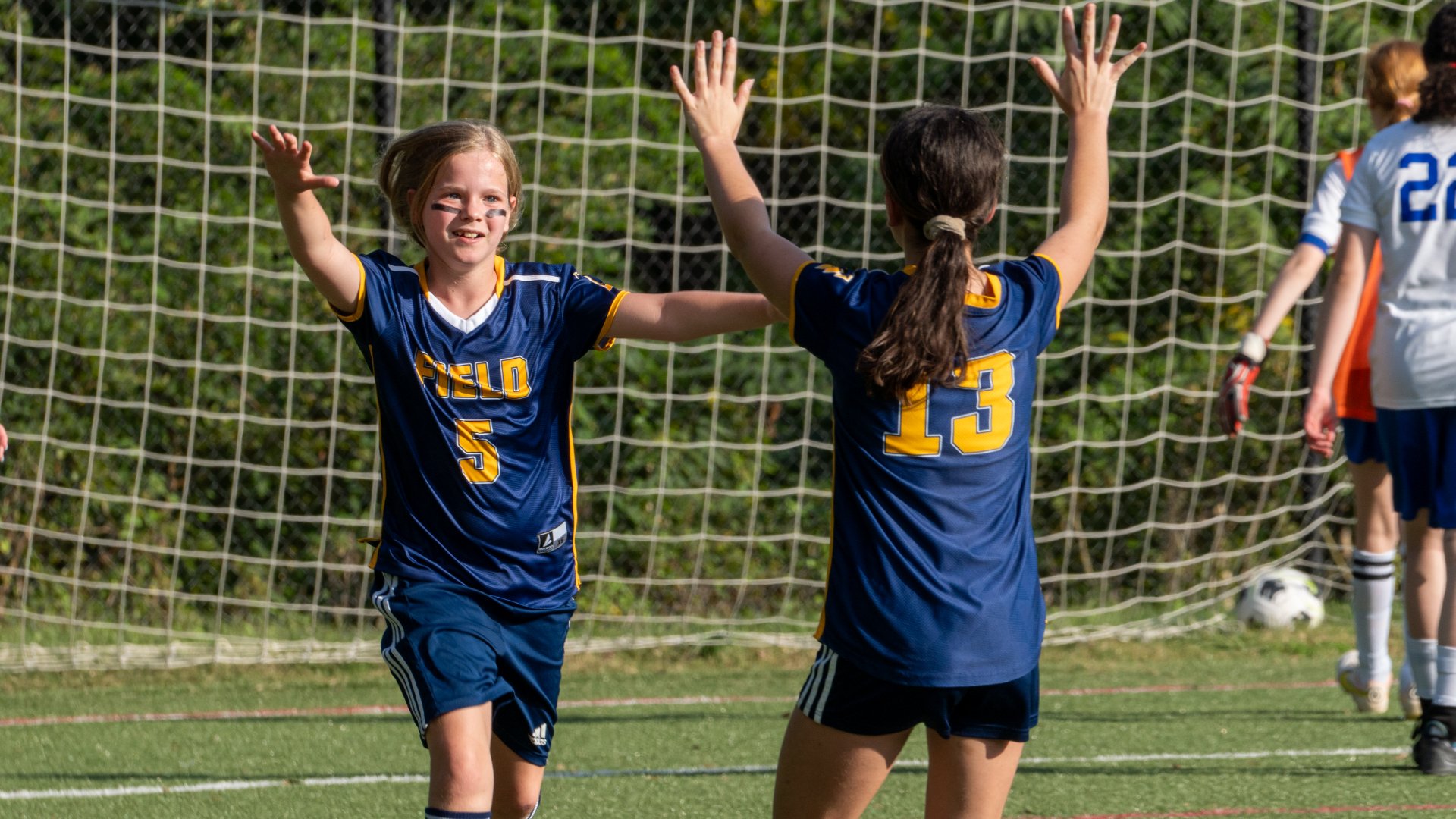 photo of students playing soccer