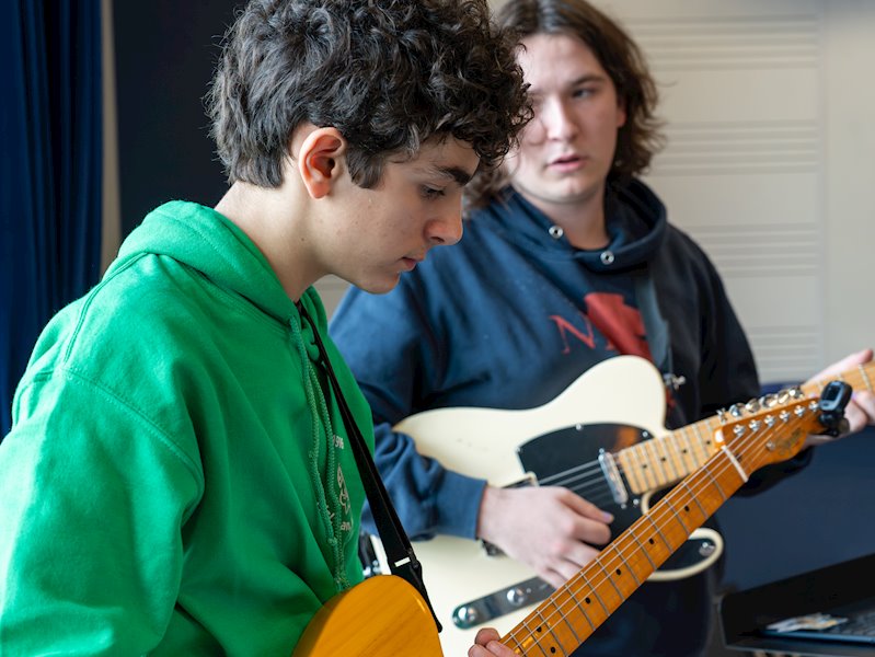 Student playing guitar